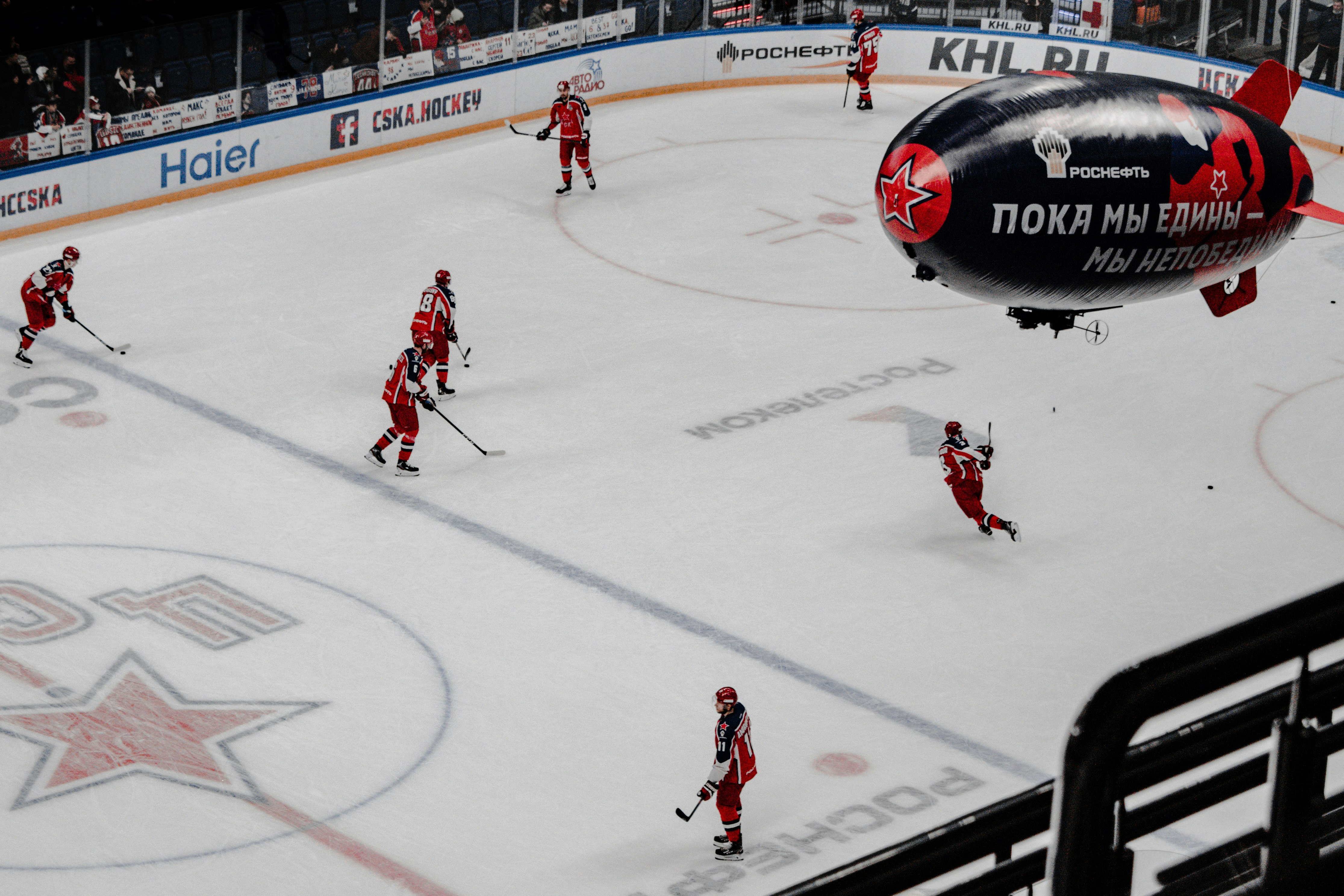 people playing ice hockey on ice stadium during daytime